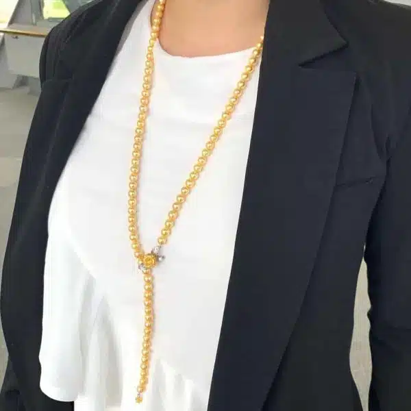 Long Gold Pearl Necklace with Floral Clasp Design